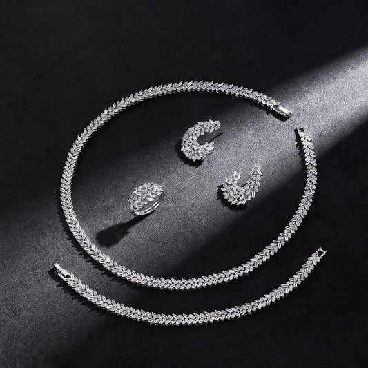 Set of leaf-shaped jewelry with cubic zirconia.
